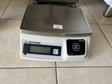 a scale that is on the floor next to a bowl