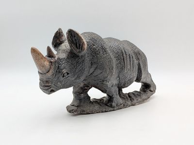 figurine of a rhino on a white background