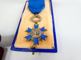 a blue and gold medal with a blue ribbon on it