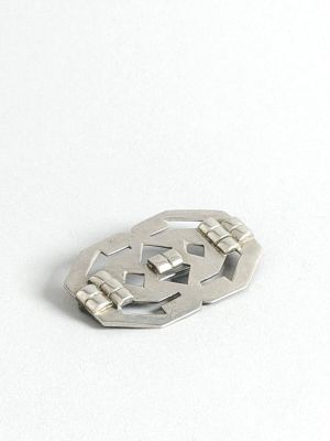 une boucle en métal argenté munie d'un fermoir métallique