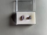a small box with a pair of earrings inside of it