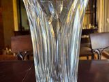 a glass vase sitting on a table in a living room