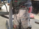 a vacuum that is sitting on the floor in the garage