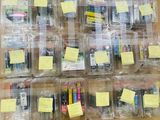 a lot of cell phones in plastic containers on a table