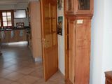 a grandfather clock in the middle of a hallway