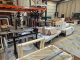 a lot of furniture in a warehouse with a lot of boxes