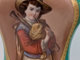 a vase with a picture of a woman holding a baby