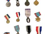 an assortment of medals and medals are displayed on a white surface