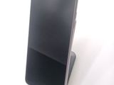 a cell phone that is sitting on top of a stand