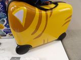 a yellow suitcase with a tiger design on it