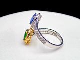 a close up of a diamond and sapphire ring on a white plate