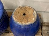 two blue vases sitting on a pallet next to each other