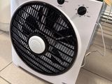 a fan that is sitting on the floor in front of a heater