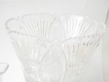 a glass vase and a glass candle holder sitting on a table