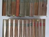 several books are stacked on top of each other on a table