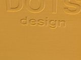 a close up of a yellow box with the words dots design on it