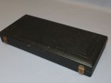 a small black box sitting on a white surface