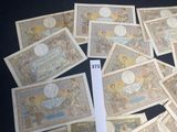 a lot of old paper money sitting on a table