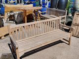 a wooden bench sitting in the middle of a lot of barrels