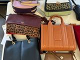 a lot of purses that are on a table
