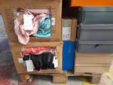 a stack of boxes with clothes on top of them