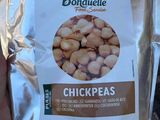 a bag of chickpeas in the hand of a person