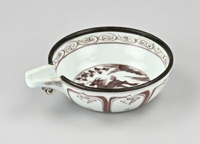 un bol blanc orné d'un motif marron et blanc