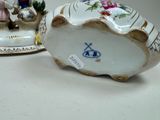 two porcelain figurines that are sitting on a table