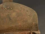 an old iron oven sitting on top of a wooden table