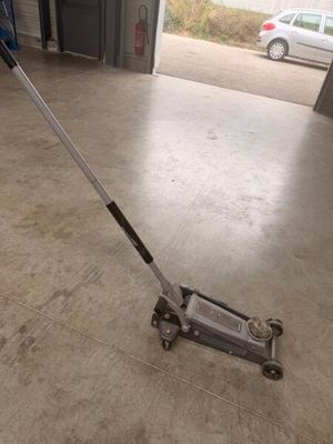 a man using a floor sweeper in a garage
