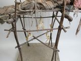 une sculpture représentant une personne allongée sur une structure en bois