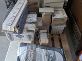 a pile of boxes on a pallet next to a door