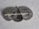 a small metal pin with a wooden stick in it