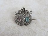 an image of a heart shaped broochle with two hearts on it