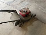 a lawn mower that is sitting on the ground