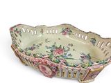 a decorative bowl with flowers on it on a white surface