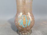 a glass vase with a gold and blue design on it