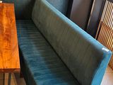 a wooden table with a blue bench in front of a mirror