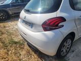 a small white car parked on the side of the road