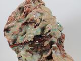 a ceramic sculpture of a man ' s head on a white surface