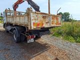 a truck that has a crane on the back of it