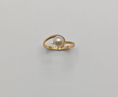 a gold ring with a pearl in the middle