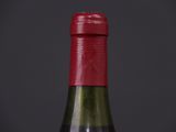 close up of a bottle of wine on a black background