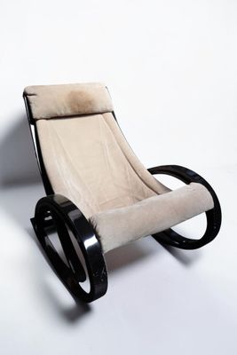 an image of a black and white rocking chair against a white wall