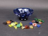 a blue bowl filled with assorted candis on a table