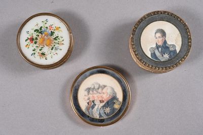 three miniature portraits of people are displayed in a gold frame