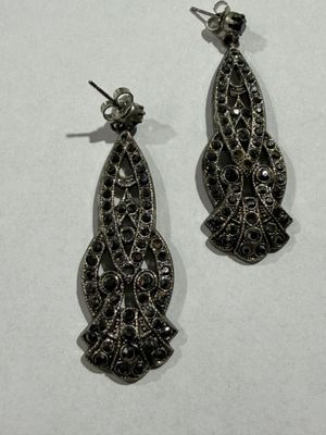 pair of black and white diamond earrings on a white surface