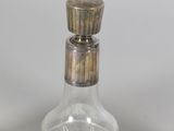 a glass bottle with a wooden stopper sitting on a table