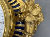a gold clock with blue and white decorations on it