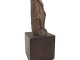 statue of a man holding a bird on a square base